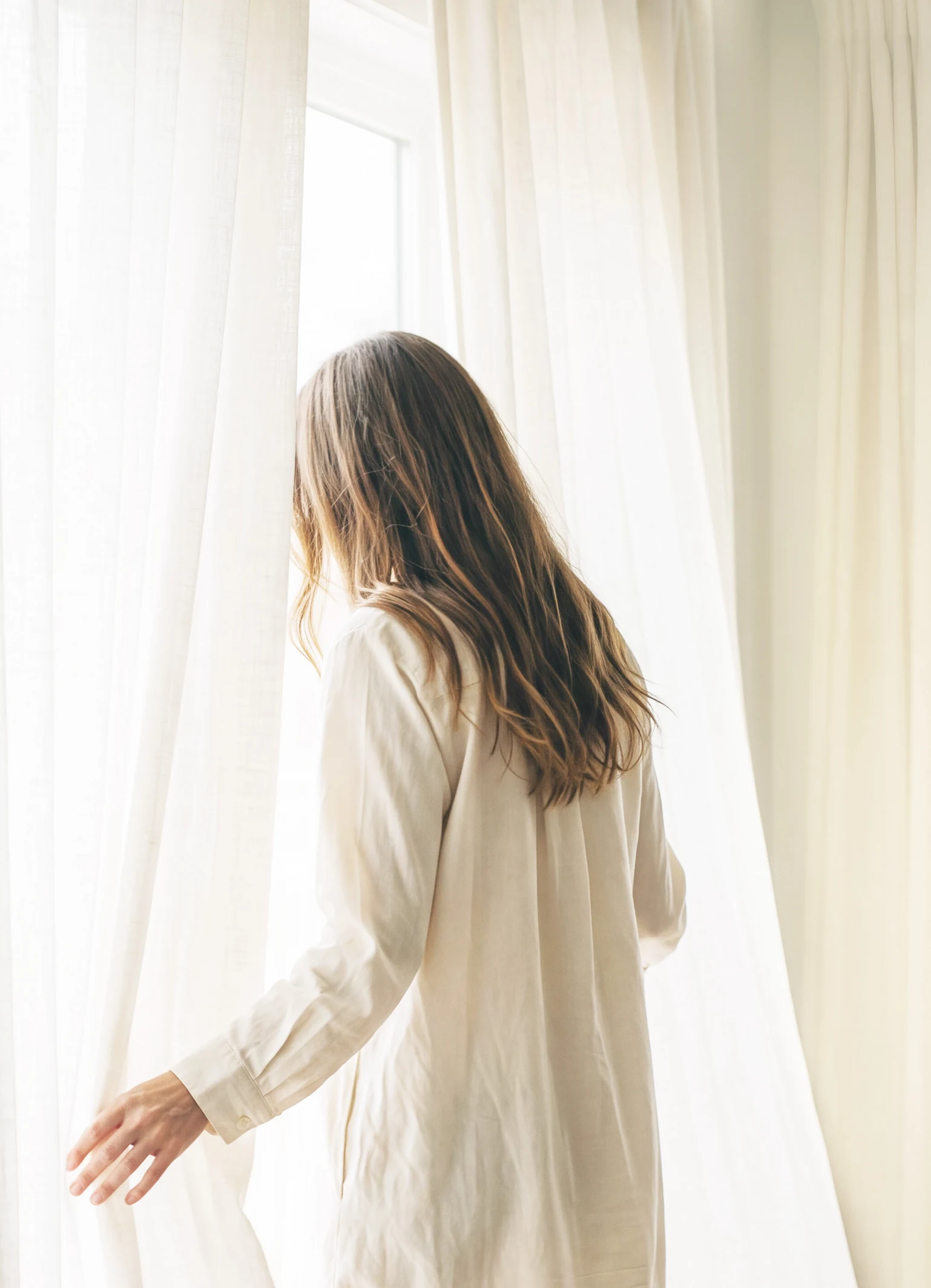 A girl at a sunlit window