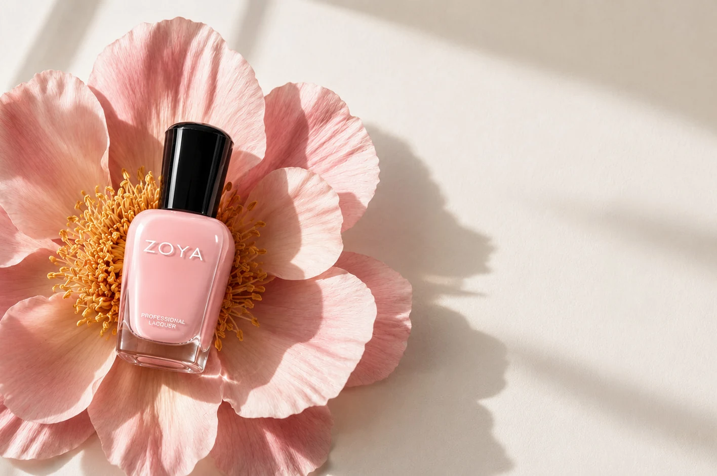 A bottle of Zoya polish resting in an open poppy